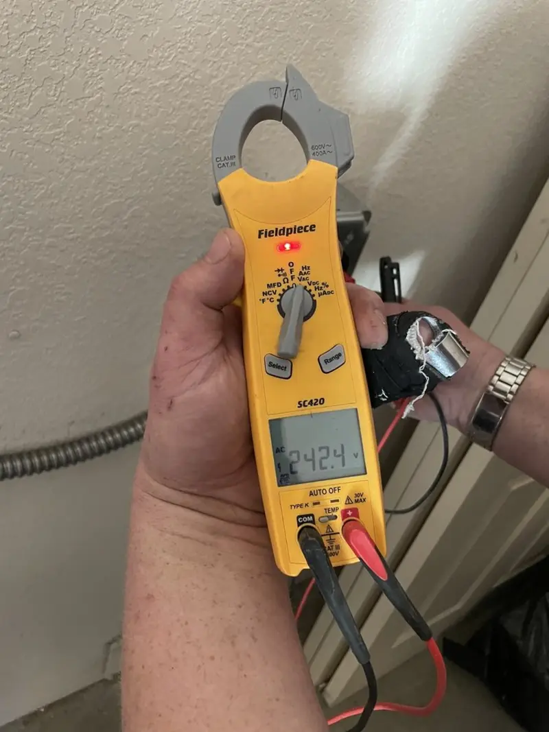 Voltage testing with clamp meter during Outlet Installation in Brownville